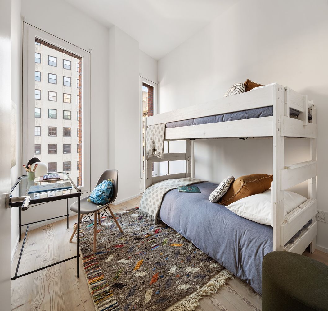 a bedroom with two beds and a window