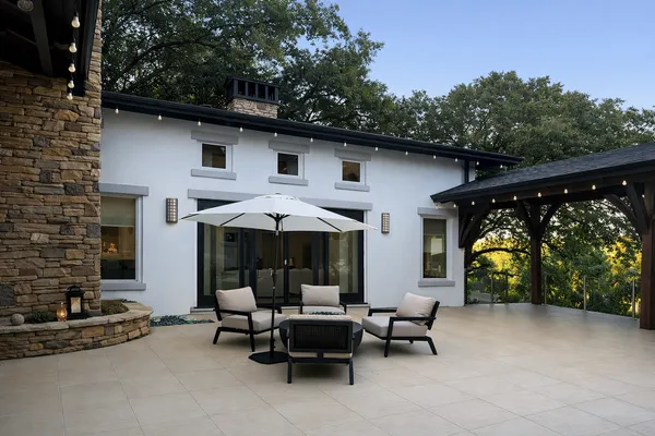 a view of a patio with table and chairs under an umbrella