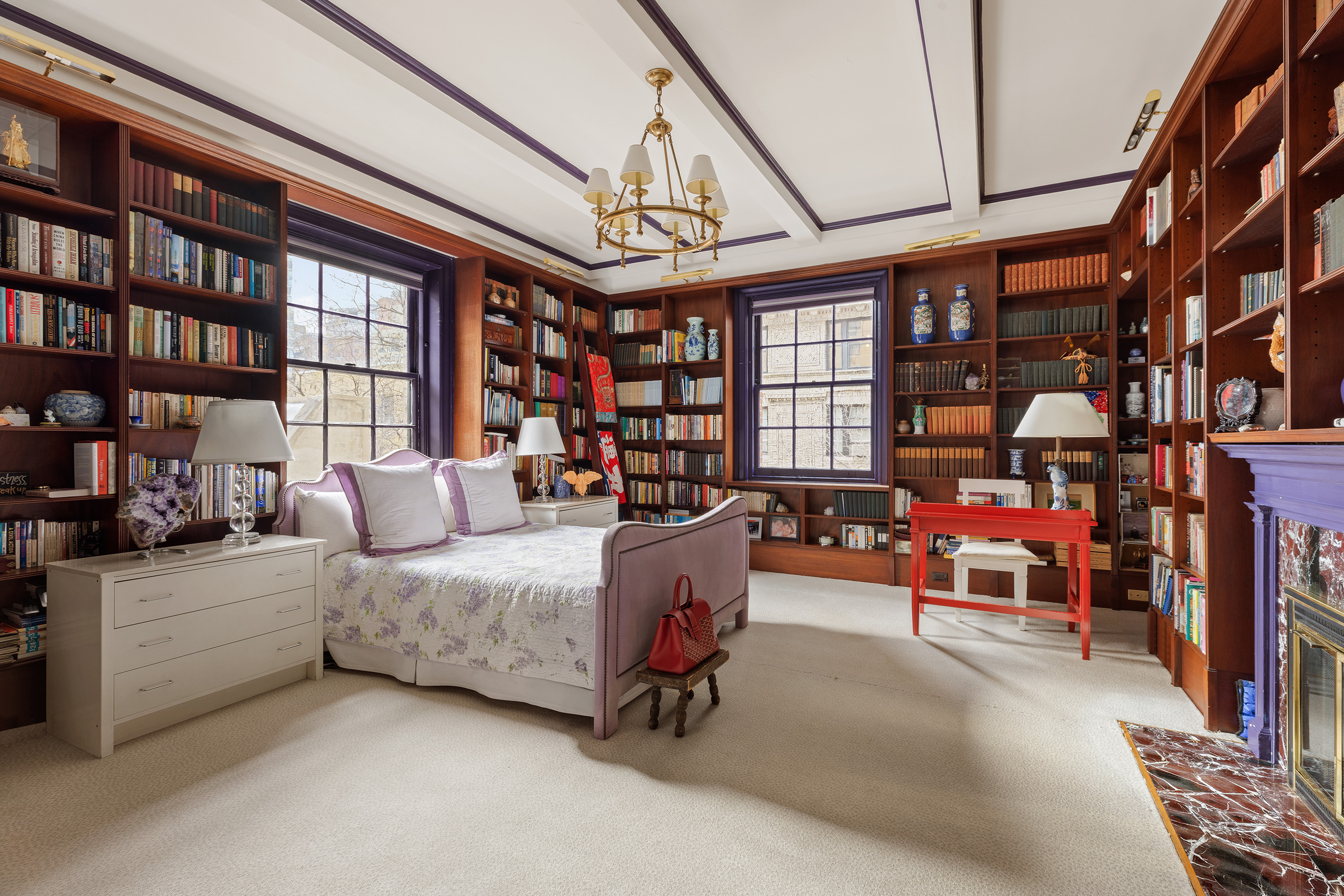 563 Park Avenue, Unit 4E Manhattan, NY 10065 - Photo 5 of 17 a living room with furniture and a book shelf