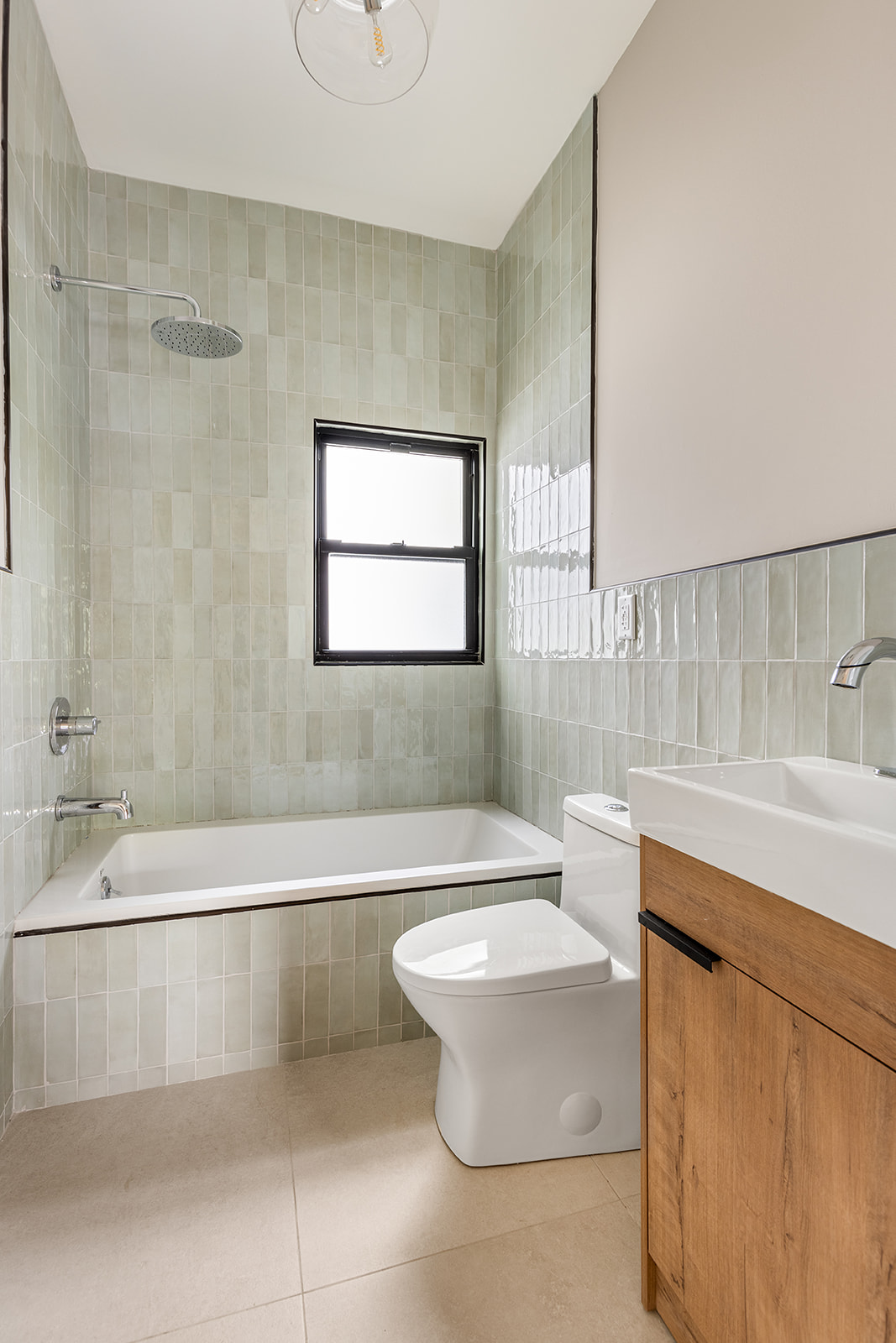 697 East 21st Street Brooklyn, NY 11210 - Photo 17 of 24 a bathroom with a sink a toilet a mirror and bathtub