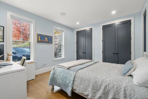 a spacious bedroom with a bed and a window