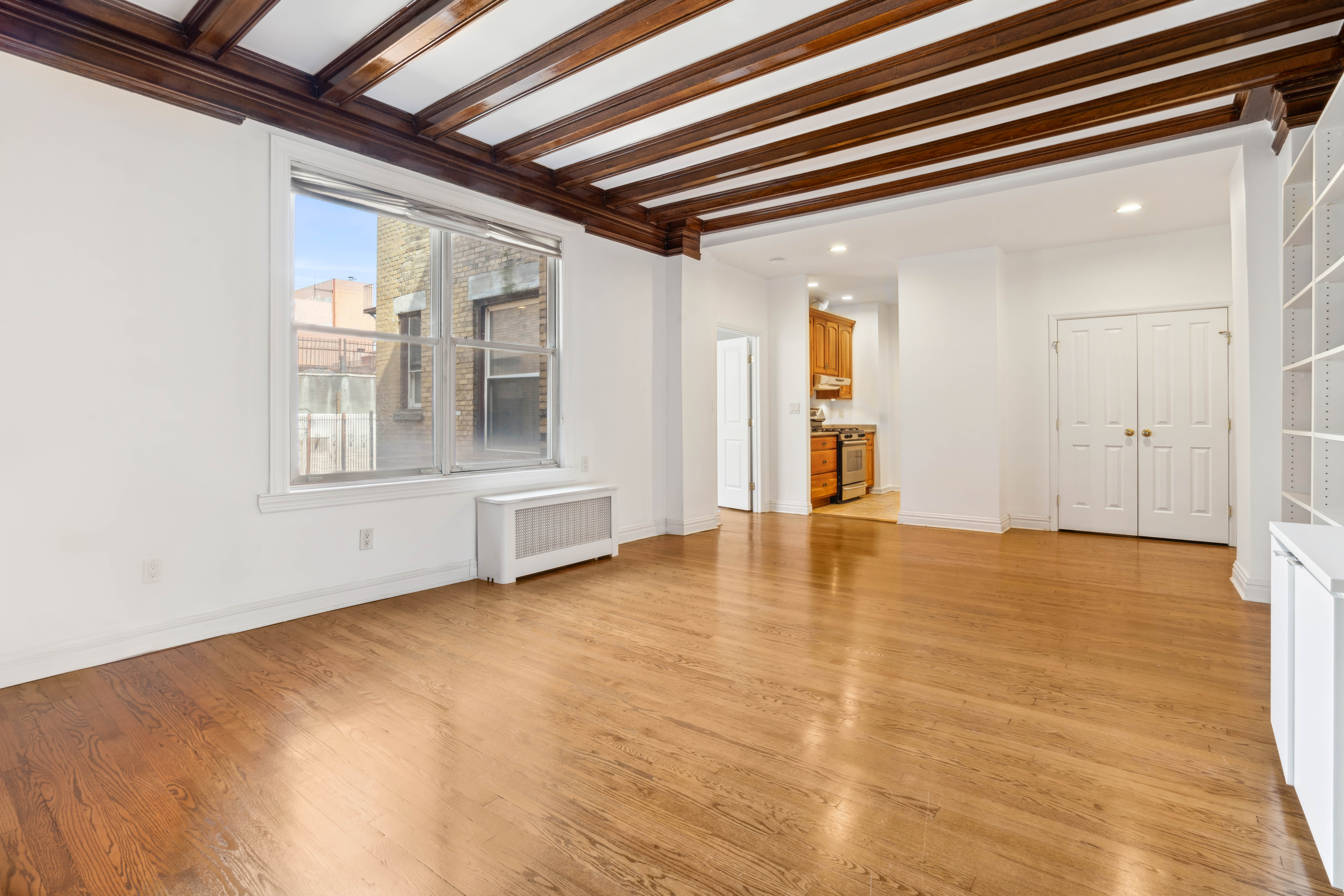 380 Riverside Drive, Unit 7B Manhattan, NY 10025 - Photo 3 of 12 a view of an empty room with wooden floor and a window
