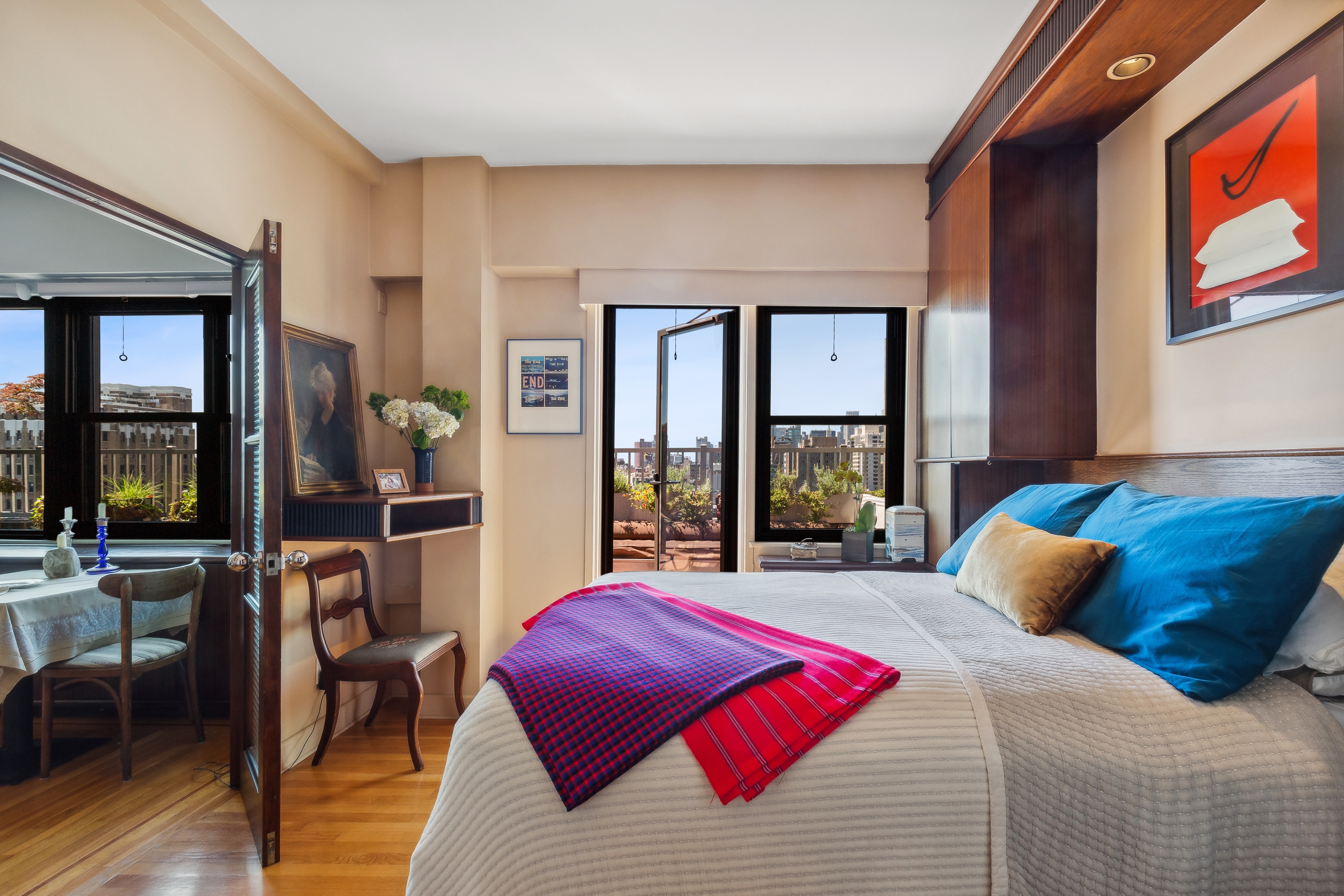 210 East 15th Street, Unit PHD Manhattan, NY 10003 - Photo 8 of 12 a bedroom with a large bed and a large window