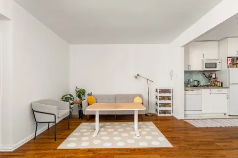 a living room with furniture and a rug