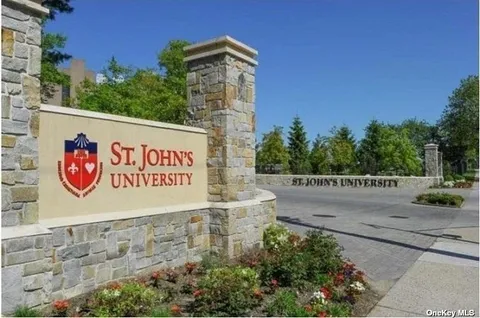 a view of a big room with a big yard and large trees