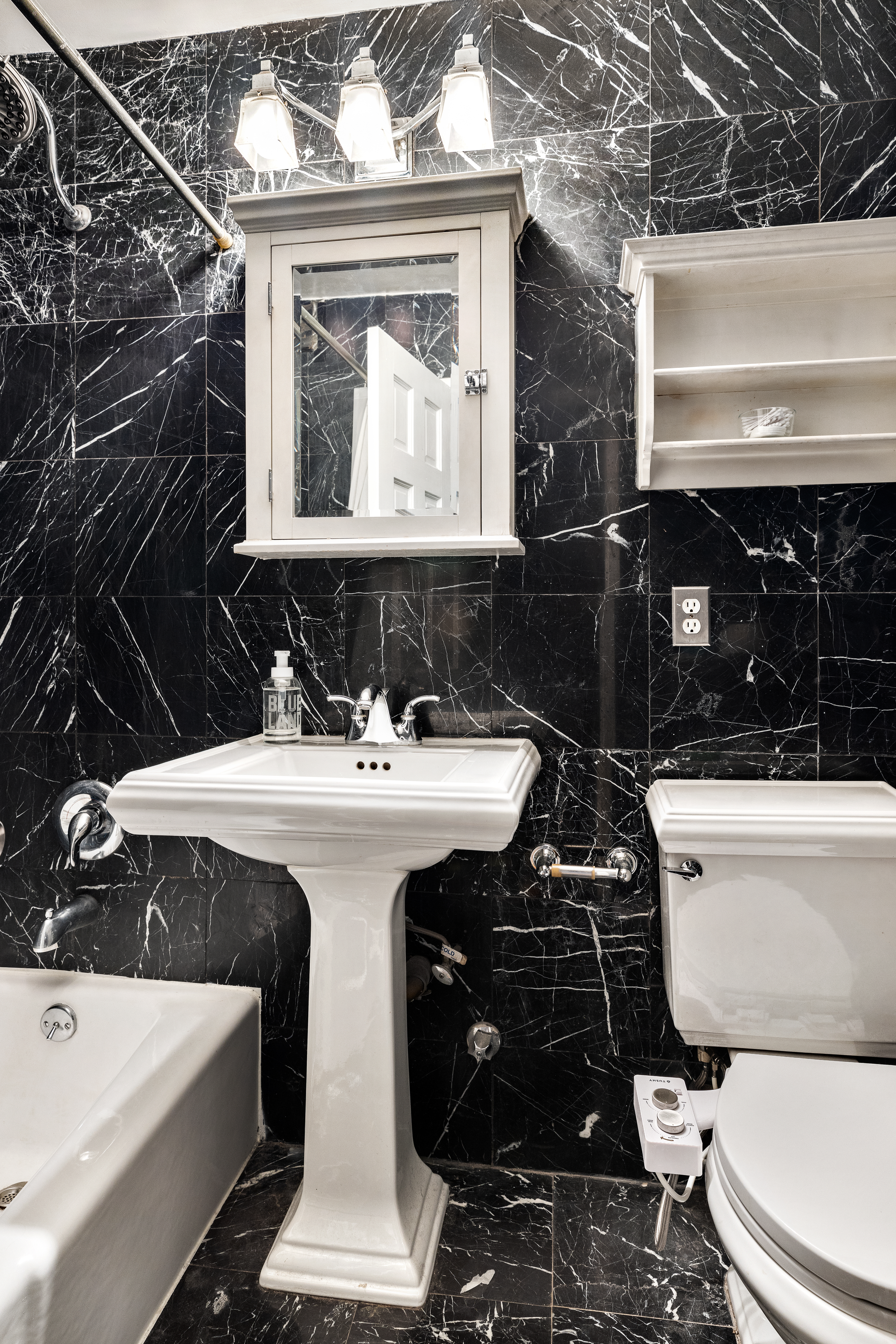 310 East 23rd Street, Unit 5H Manhattan, NY 10010 - Photo 4 of 8 a bathroom with a sink a toilet and shower