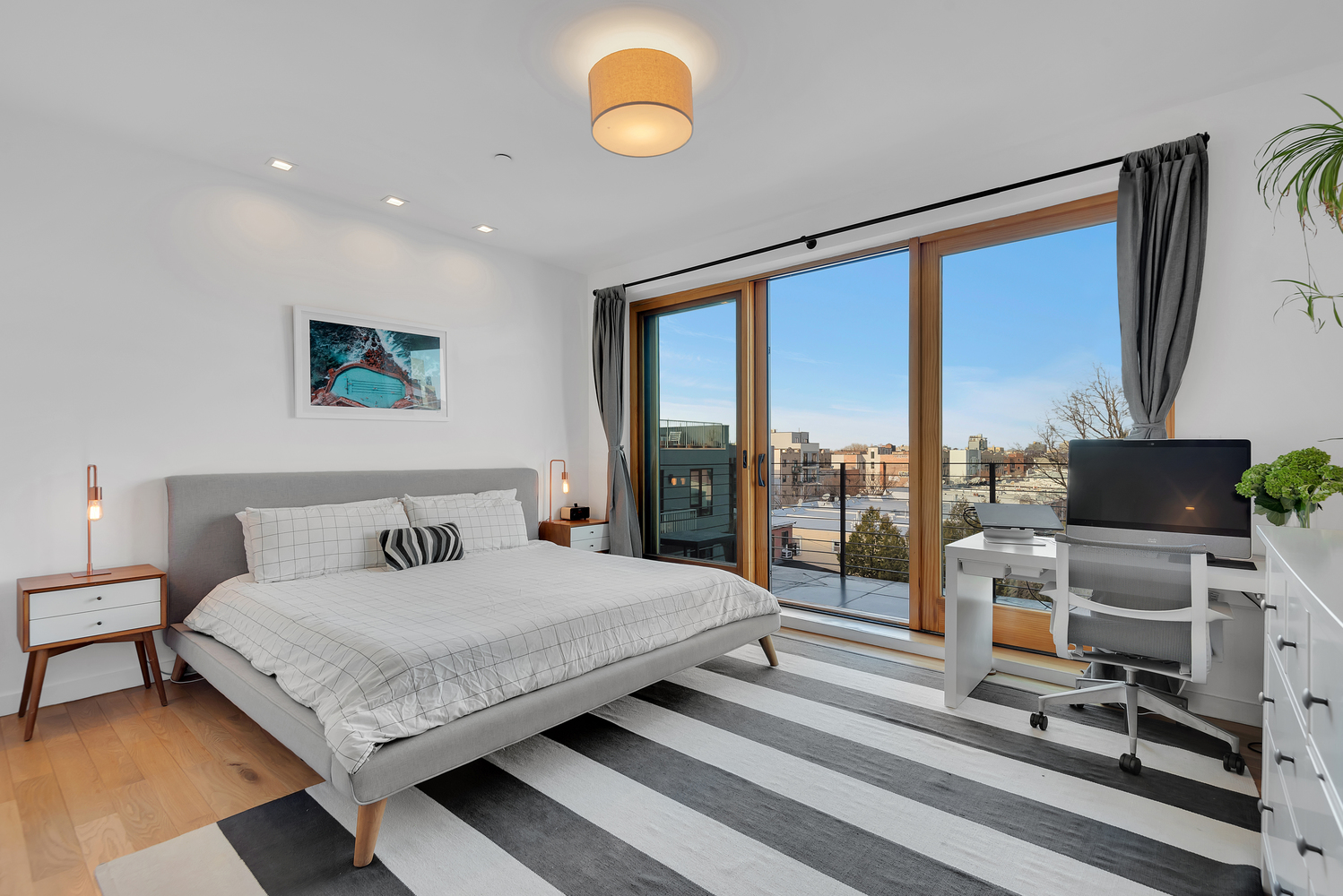 267 Evergreen Avenue, Unit PH Brooklyn, NY 11221 - Photo 10 of 19 a bedroom with a bed and glass wall