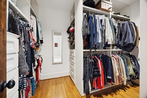 a view of walk in closet with clothes
