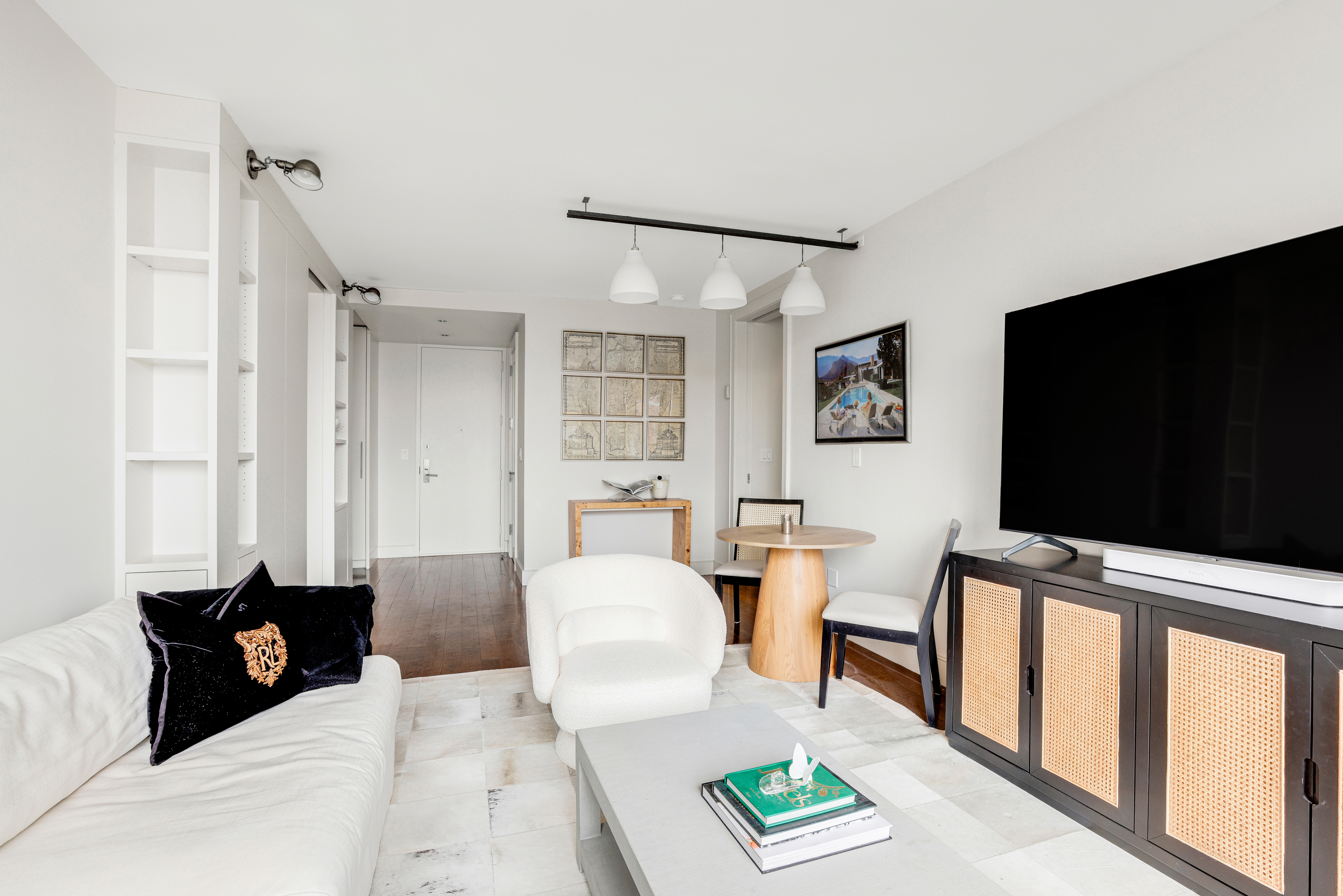 111 West 67th Street, Unit 34F Manhattan, NY 10023 - Photo 3 of 11 a living room with furniture and a flat screen tv