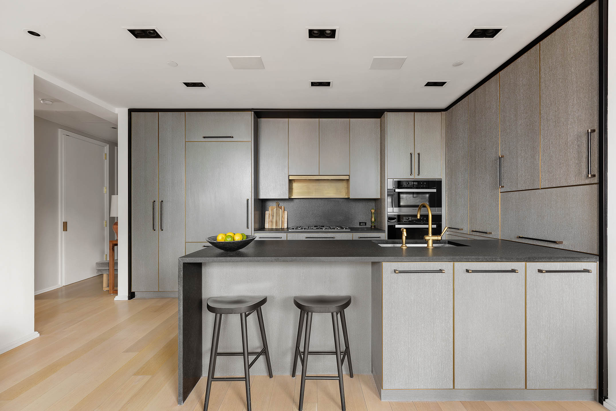 505 West 19th Street, Unit 8C Manhattan, NY 10011 - Photo 6 of 13 a kitchen with stainless steel appliances a sink a stove a refrigerator cabinets and a dining table