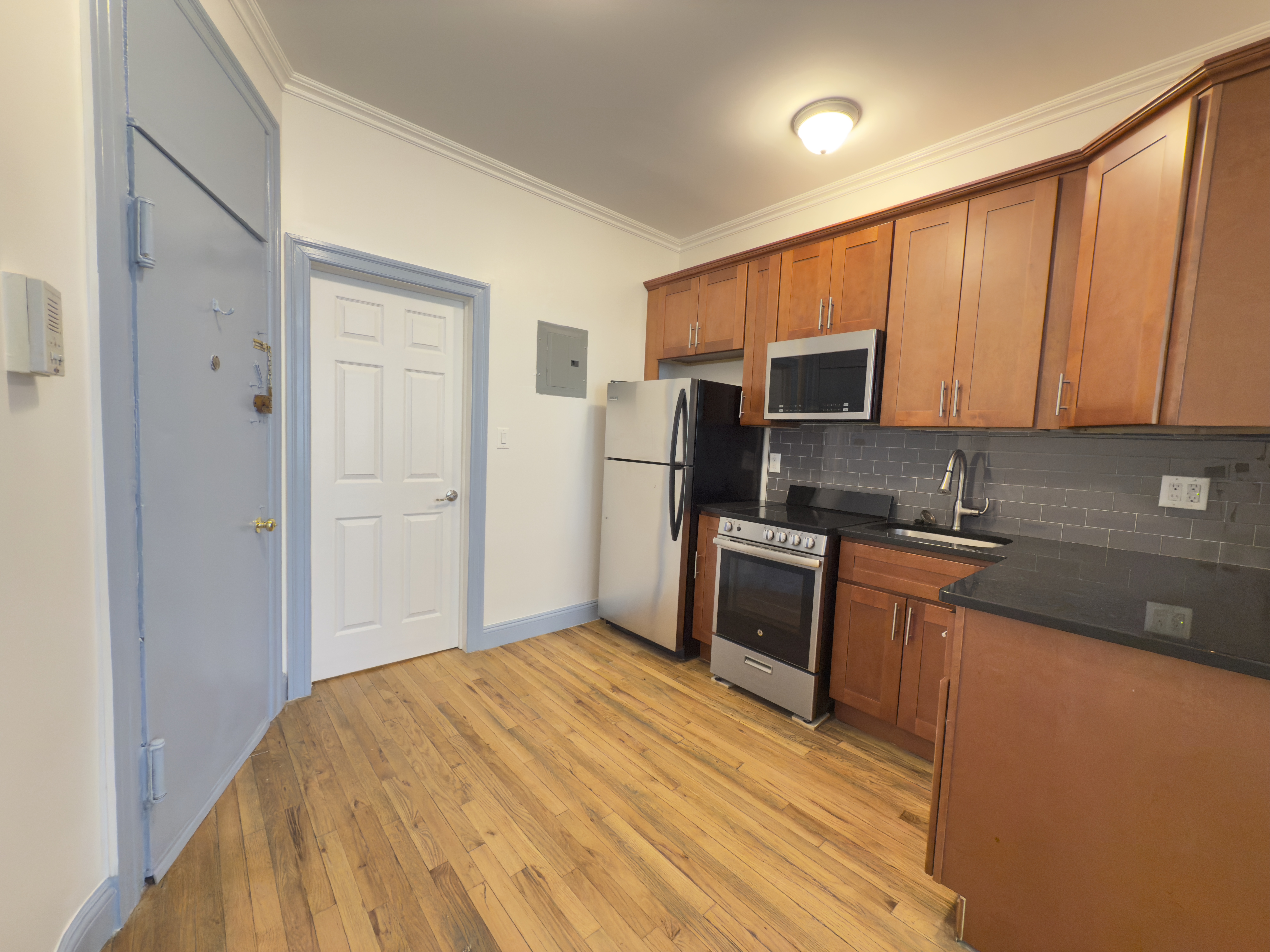 398 3rd Avenue, Unit 2C Manhattan, NY 10016 - Photo 3 of 6 a kitchen with stainless steel appliances granite countertop a refrigerator stove and sink