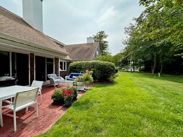 a view of a house with backyard porch and sitting area