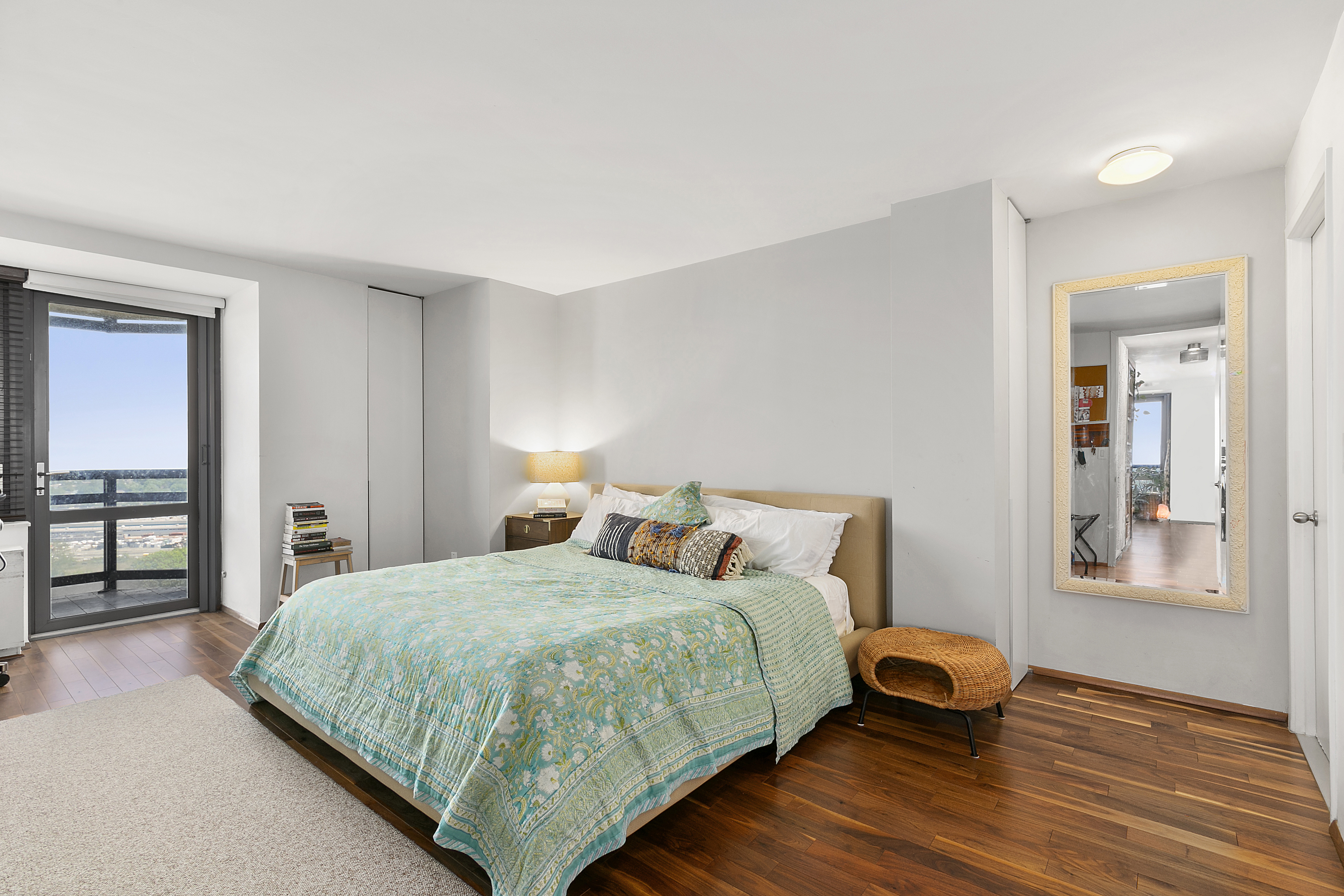 112-01 Queens Boulevard, Unit 18H Queens, NY 11375 - Photo 7 of 25 a bedroom with a bed and a table