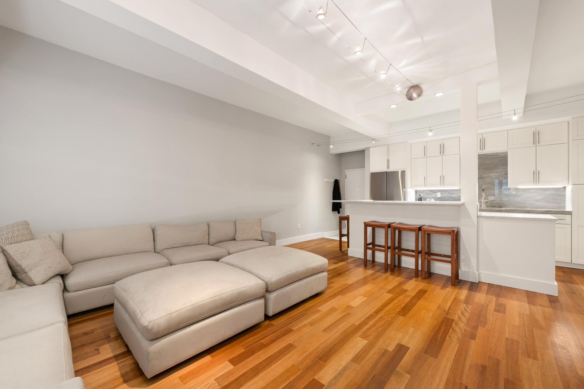 a living room with furniture and a wooden floor