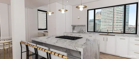 a kitchen that has a sink and a stove in it