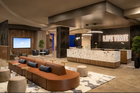 a view of a room with gym equipment and floor to ceiling windows