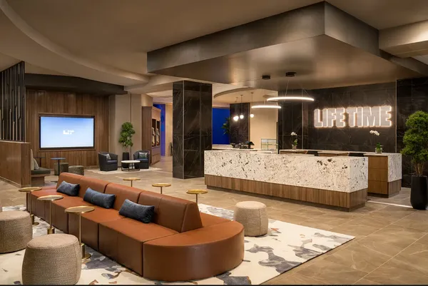 a view of a room with gym equipment and floor to ceiling windows