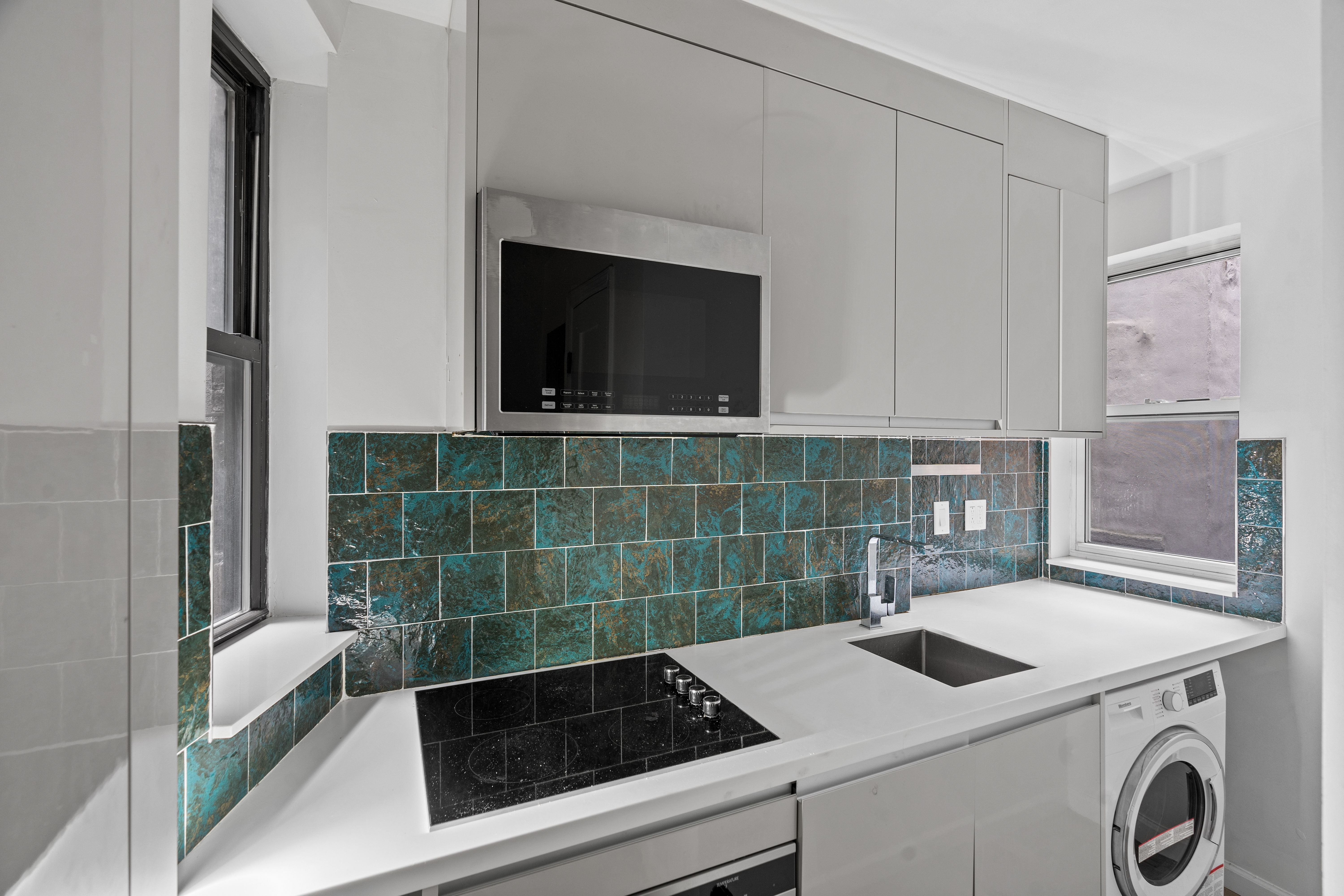 746 9th Avenue, Unit 4DF Manhattan, NY 10019 - Photo 9 of 13 a view of bathroom with washing machine and sink