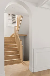 a picture of a bedroom with a white bed and a cabinets