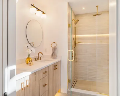 a bathroom with a sink vanity granite shower and a mirror