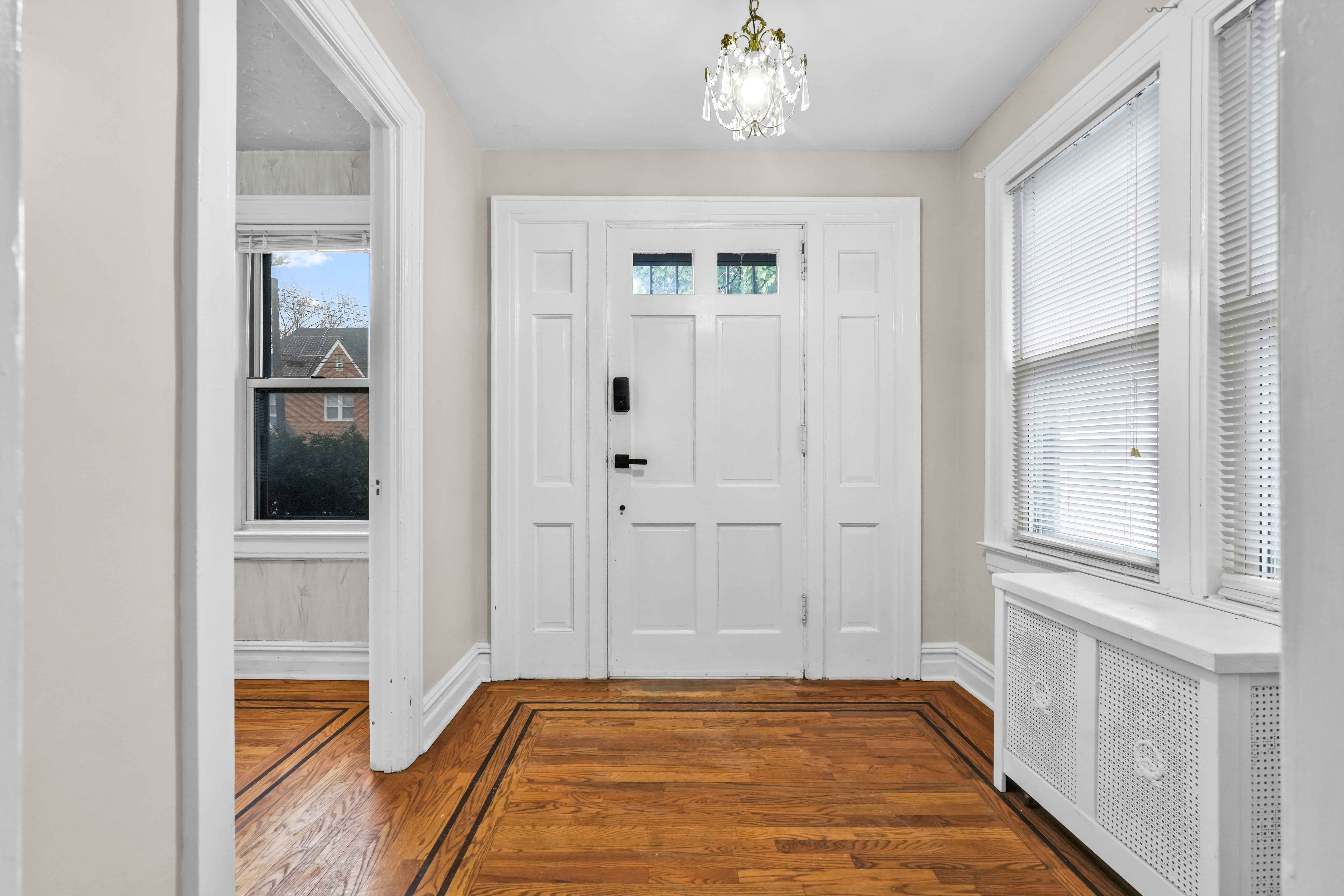 188-22 Lewiston Avenue, Unit 1 Queens, NY 11412 - Photo 2 of 17 a view of a livingroom with wooden floor and a kitchen space