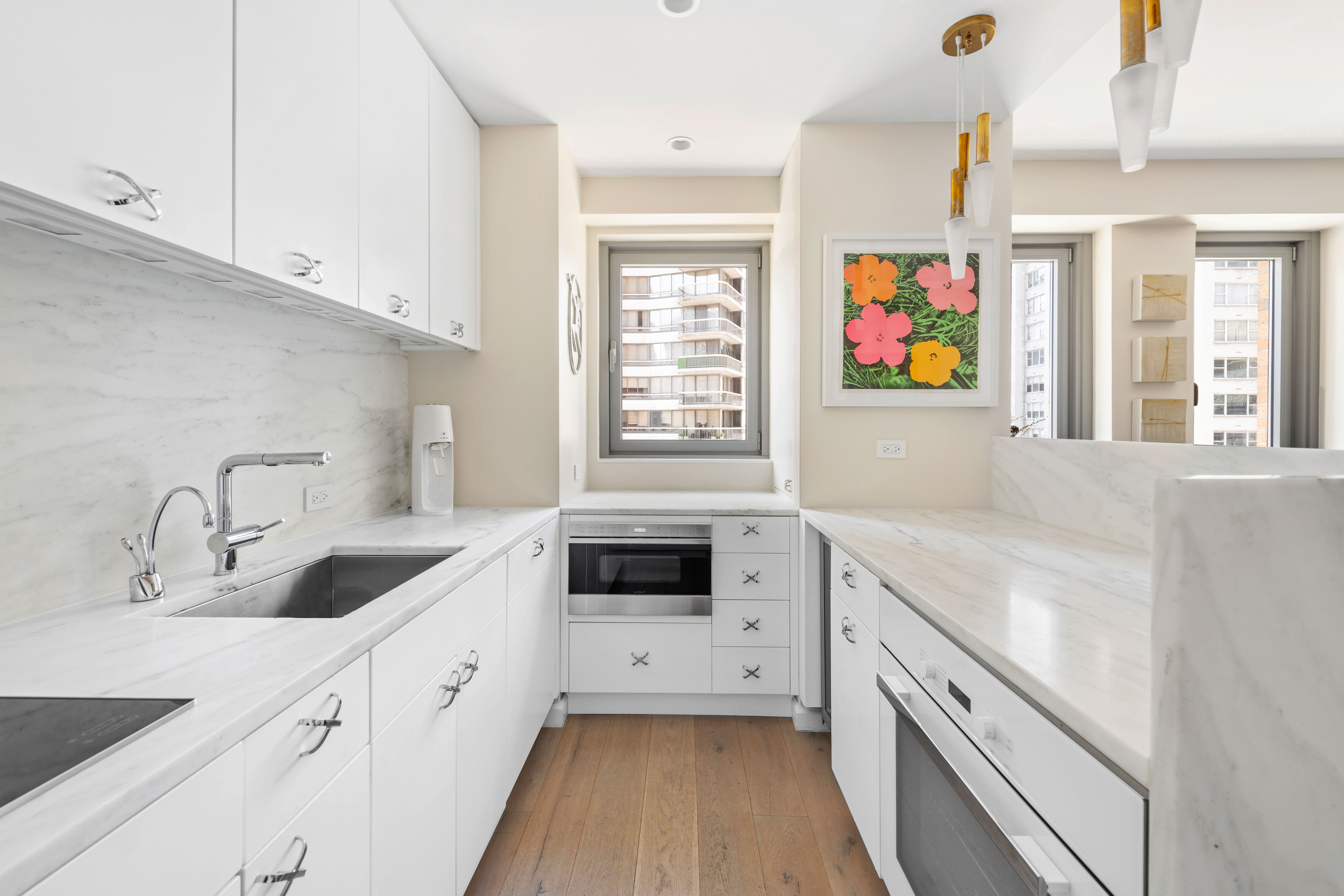 200 East 62nd Street, Unit 5A Manhattan, NY 10065 - Photo 9 of 25 a kitchen with granite countertop a sink stove and cabinets