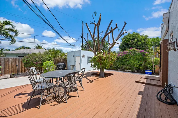a view of a patio with table and chairs and potted plants