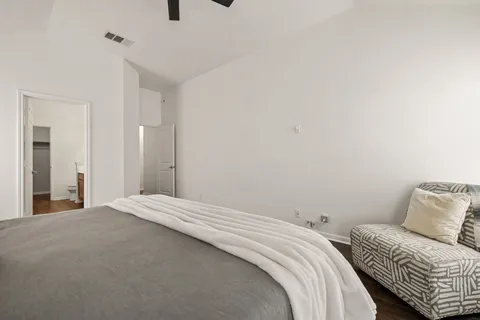 a bedroom with a bed and a mirror