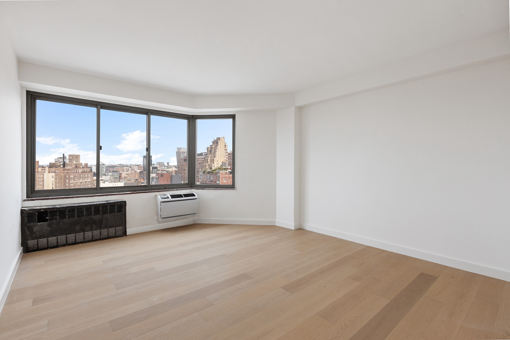 175 West 12th Street, Unit 20E Manhattan, NY 10011 - Photo 5 of 12 an empty room with a large window and view of outdoor space
