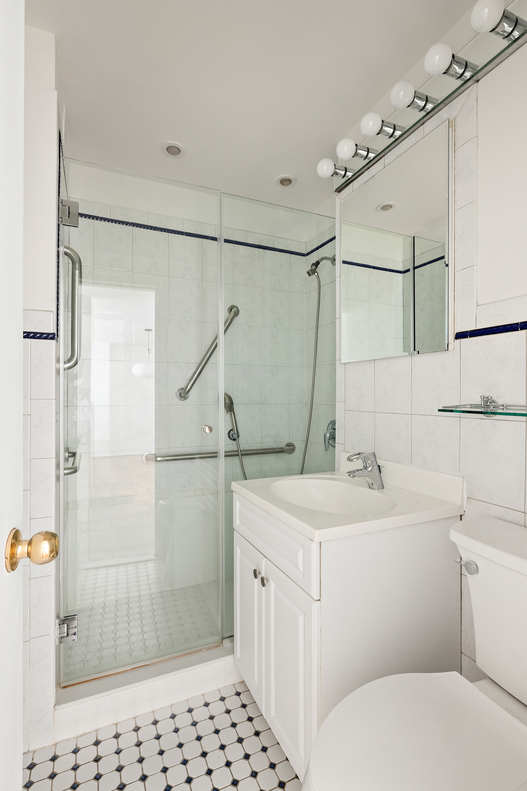 55 East 87th Street, Unit 9M Manhattan, NY 10128 - Photo 9 of 11 a bathroom with a sink toilet and shower