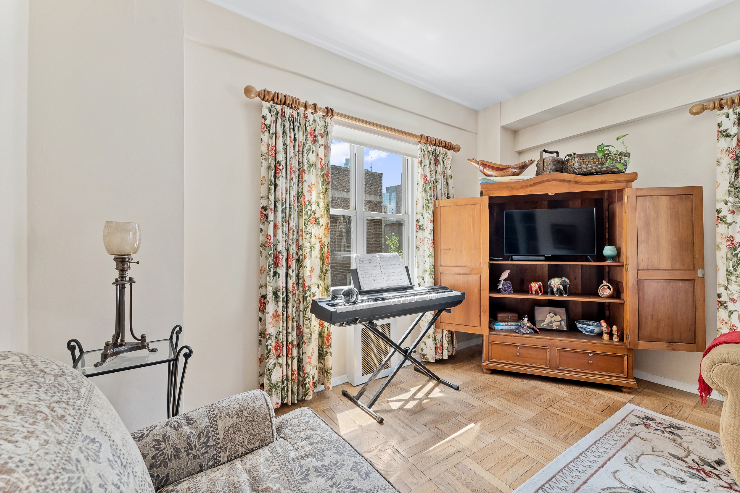 310 Lexington Avenue, Unit 15A Manhattan, NY 10016 - Photo 5 of 17 a living room with furniture and a flat screen tv