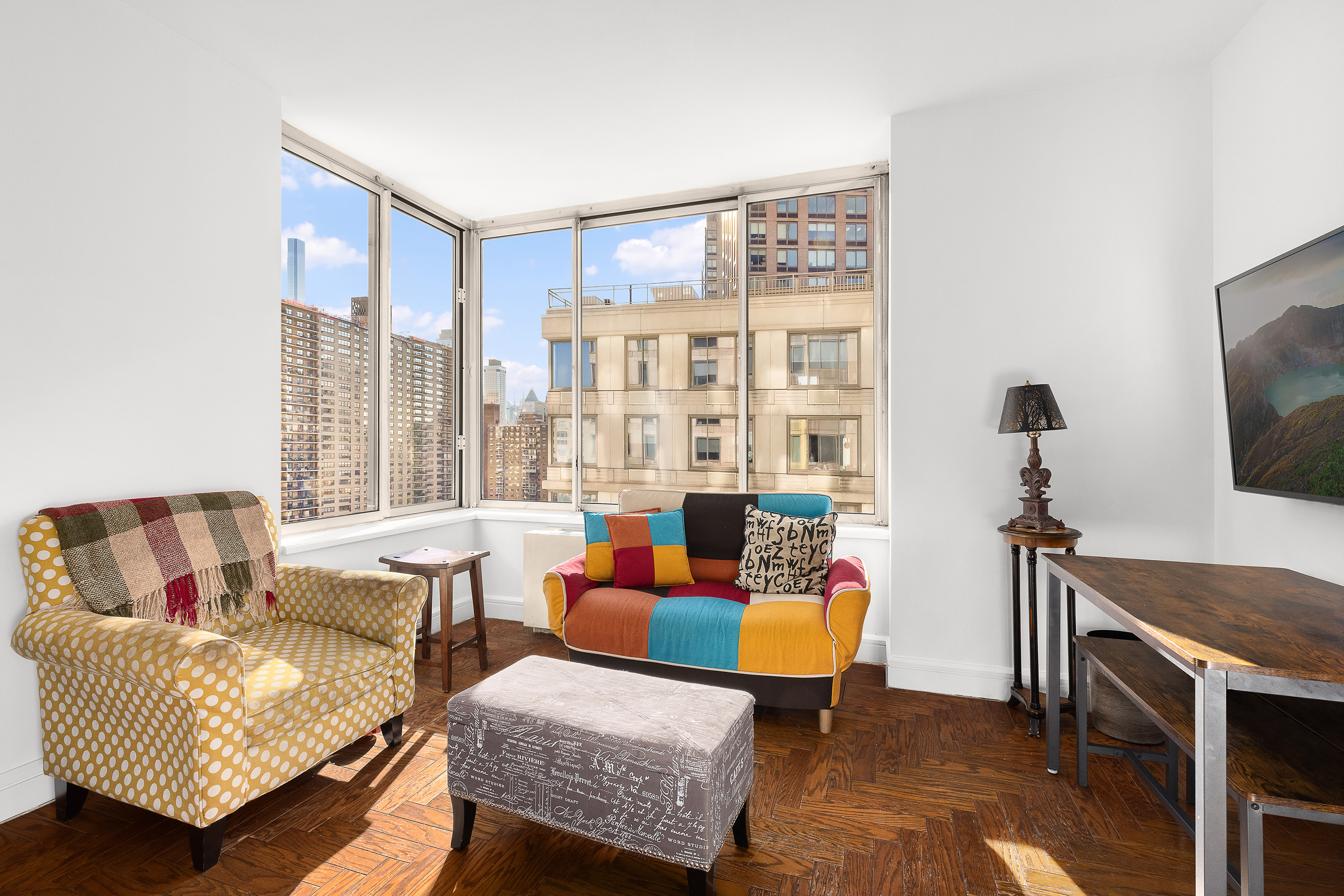 200 Riverside Boulevard, Unit 15F Manhattan, NY 10069 - Photo 4 of 11 a living room with furniture and a flat screen tv