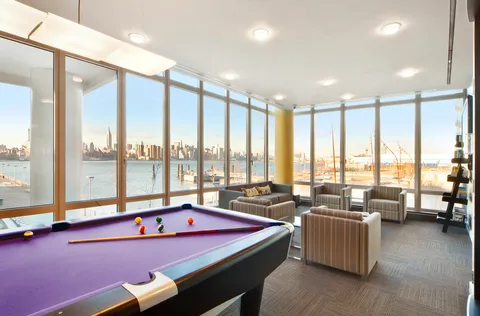 a living room with furniture city view and large windows