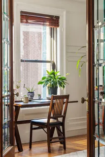 a dining room with furniture and window
