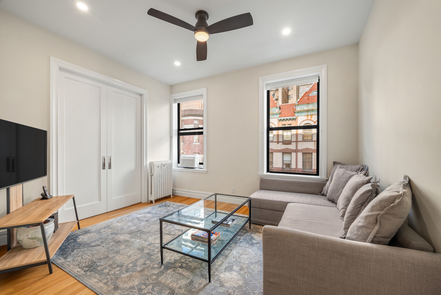 334 West 85th Street, Unit 3A Manhattan, NY 10024 - Photo 2 of 8 a living room with furniture and a flat screen tv