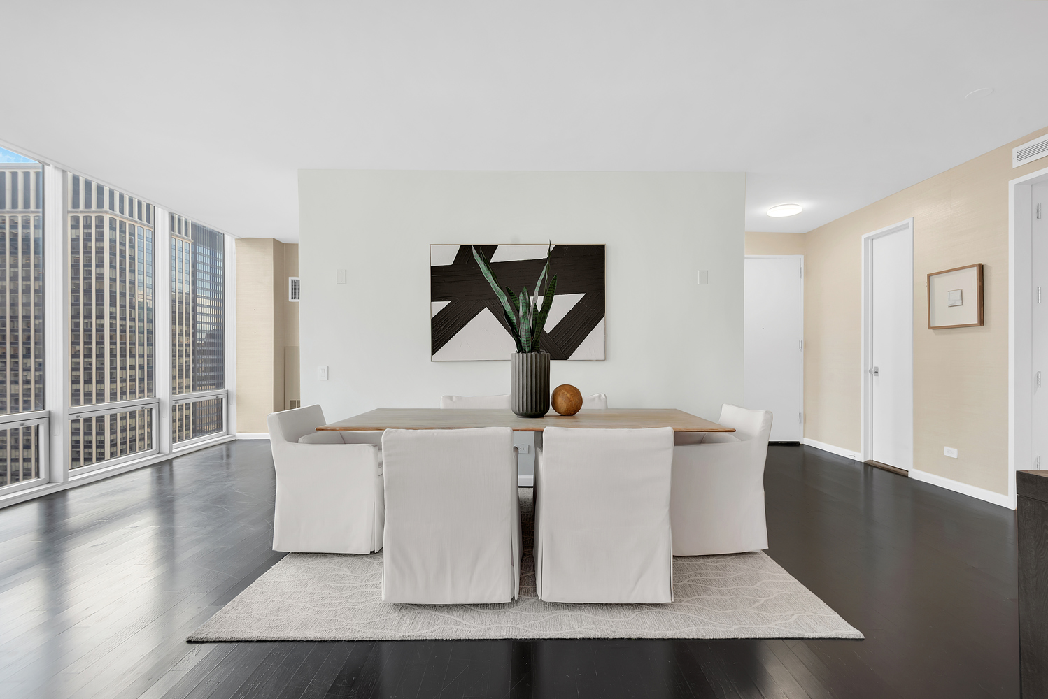 641 5th Avenue, Unit 26D Manhattan, NY 10022 - Photo 5 of 13 a living room with couches and a large window with wooden floor
