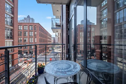 a view of a balcony dining area and chandelier