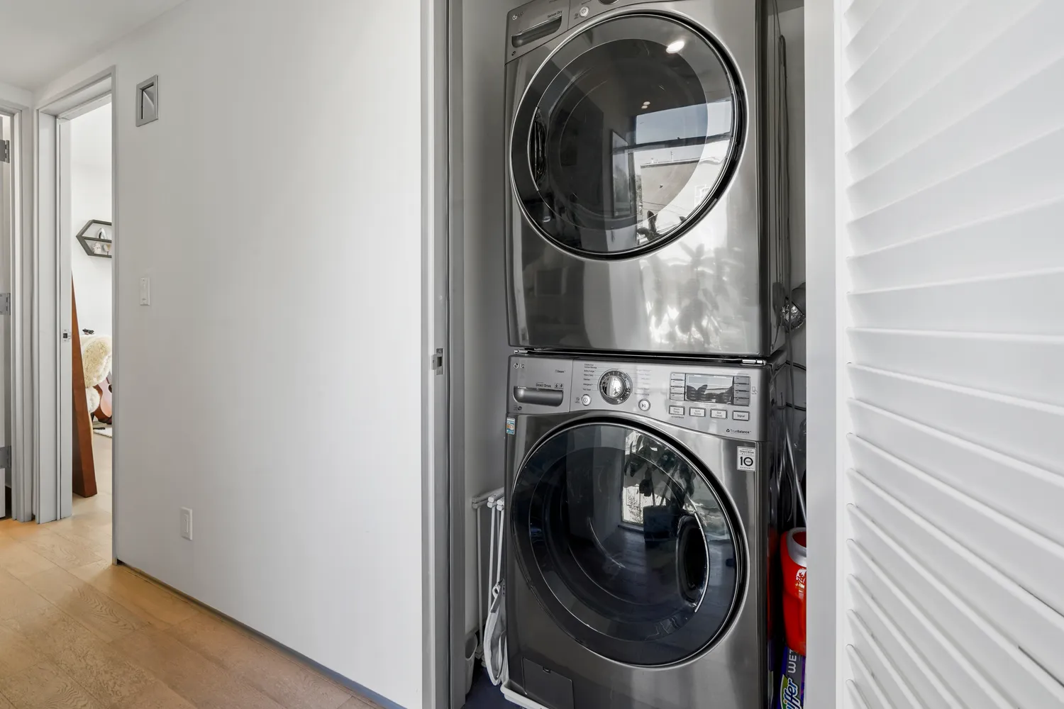 a view of a hallway with washer and dryer
