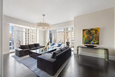 a living room with fireplace furniture and a large window