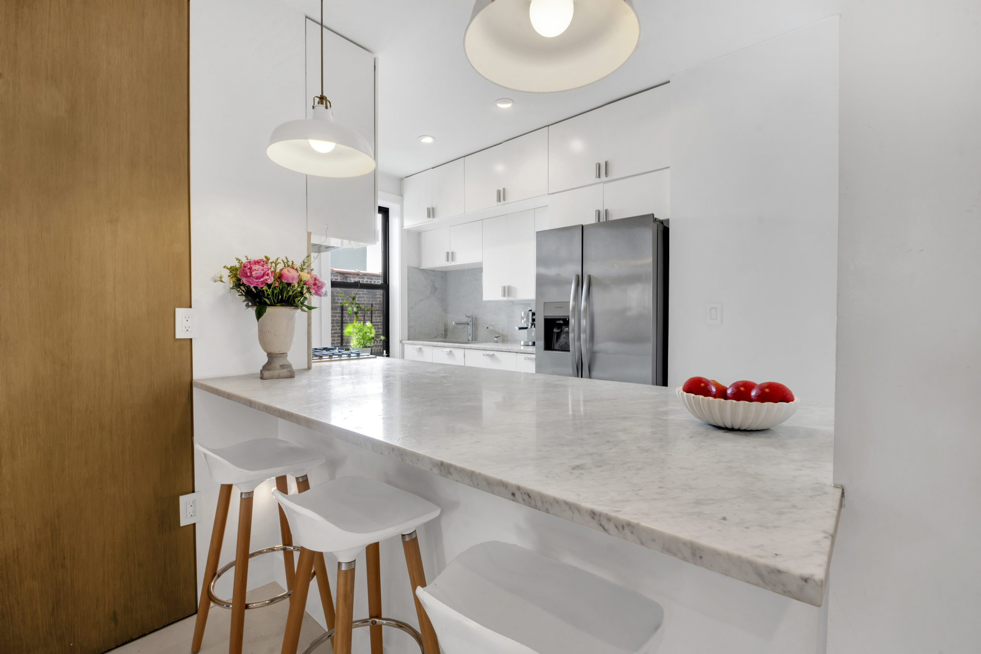 47 Fort Washington Avenue, Unit 61 Manhattan, NY 10032 - Photo 6 of 14 a kitchen with granite countertop a table and chairs in it