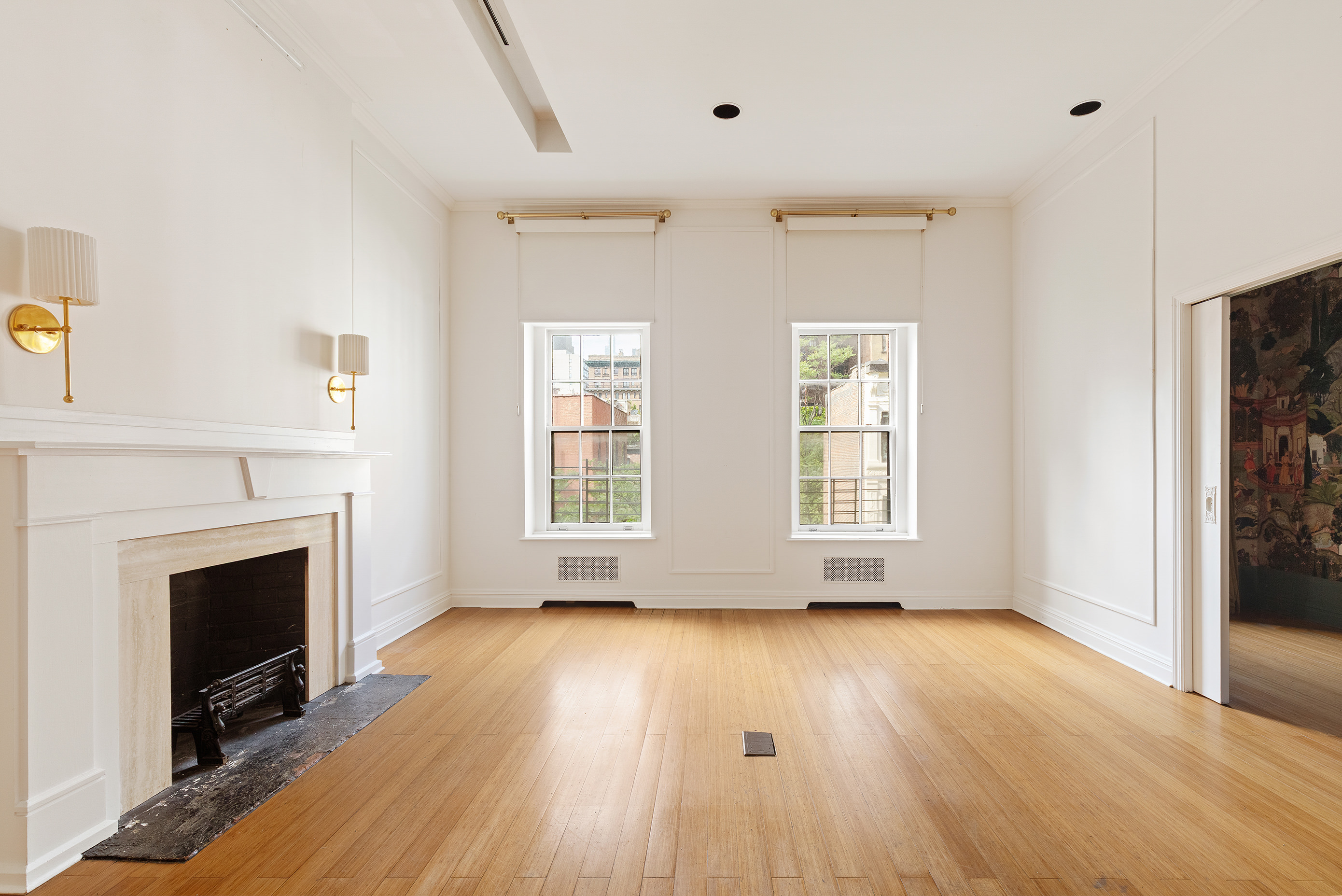 126 East 19th Street Manhattan, NY 10003 - Photo 2 of 13 a view of empty room with wooden floor and fireplace