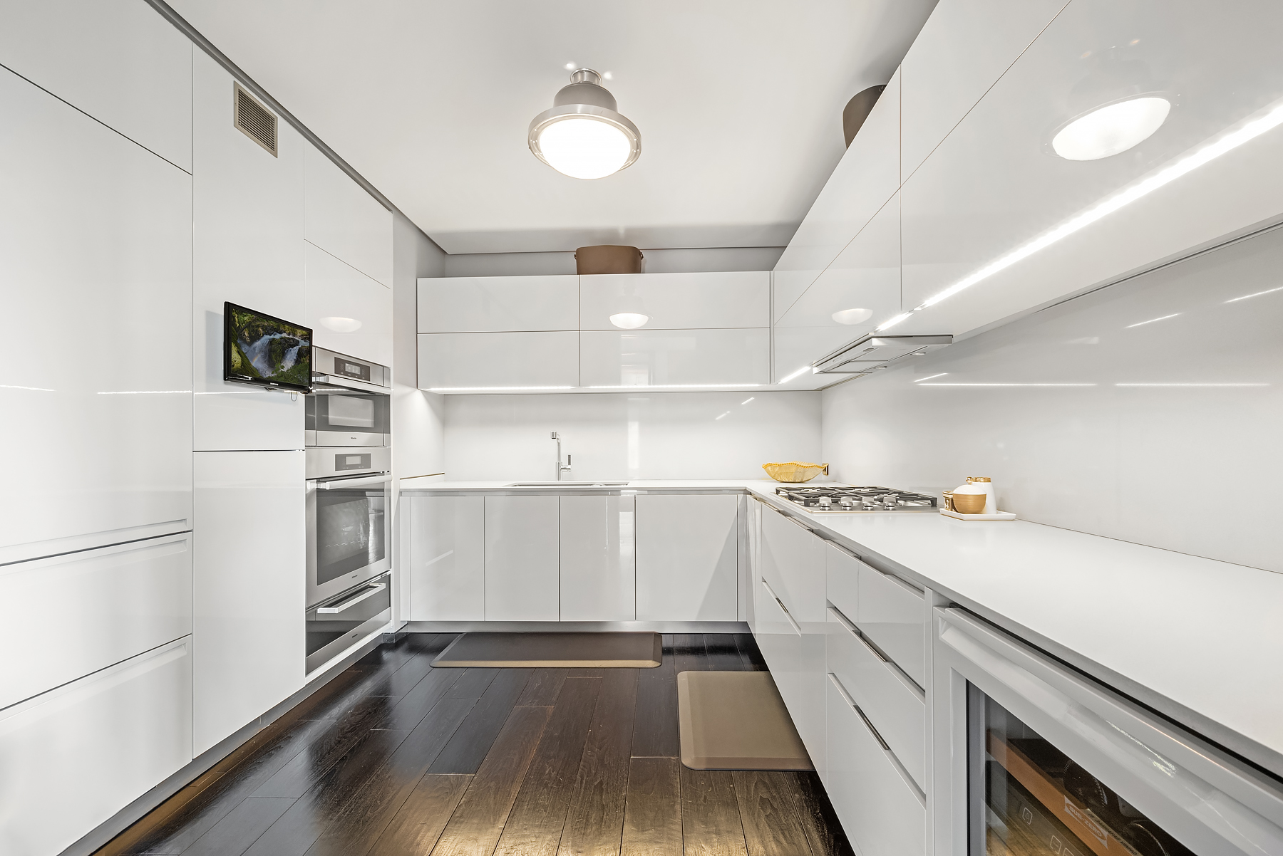 279 Central Park West, Unit 8B Manhattan, NY 10024 - Photo 4 of 15 a kitchen with white cabinets and white appliances