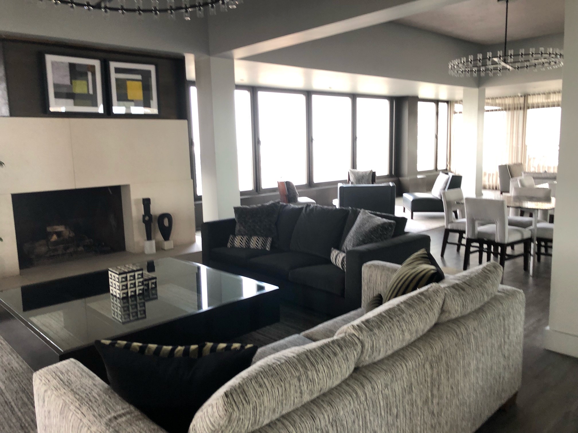 117 East 57th Street, Unit 21H Manhattan, NY 10022 - Photo 22 of 26 a living room with furniture and a fireplace