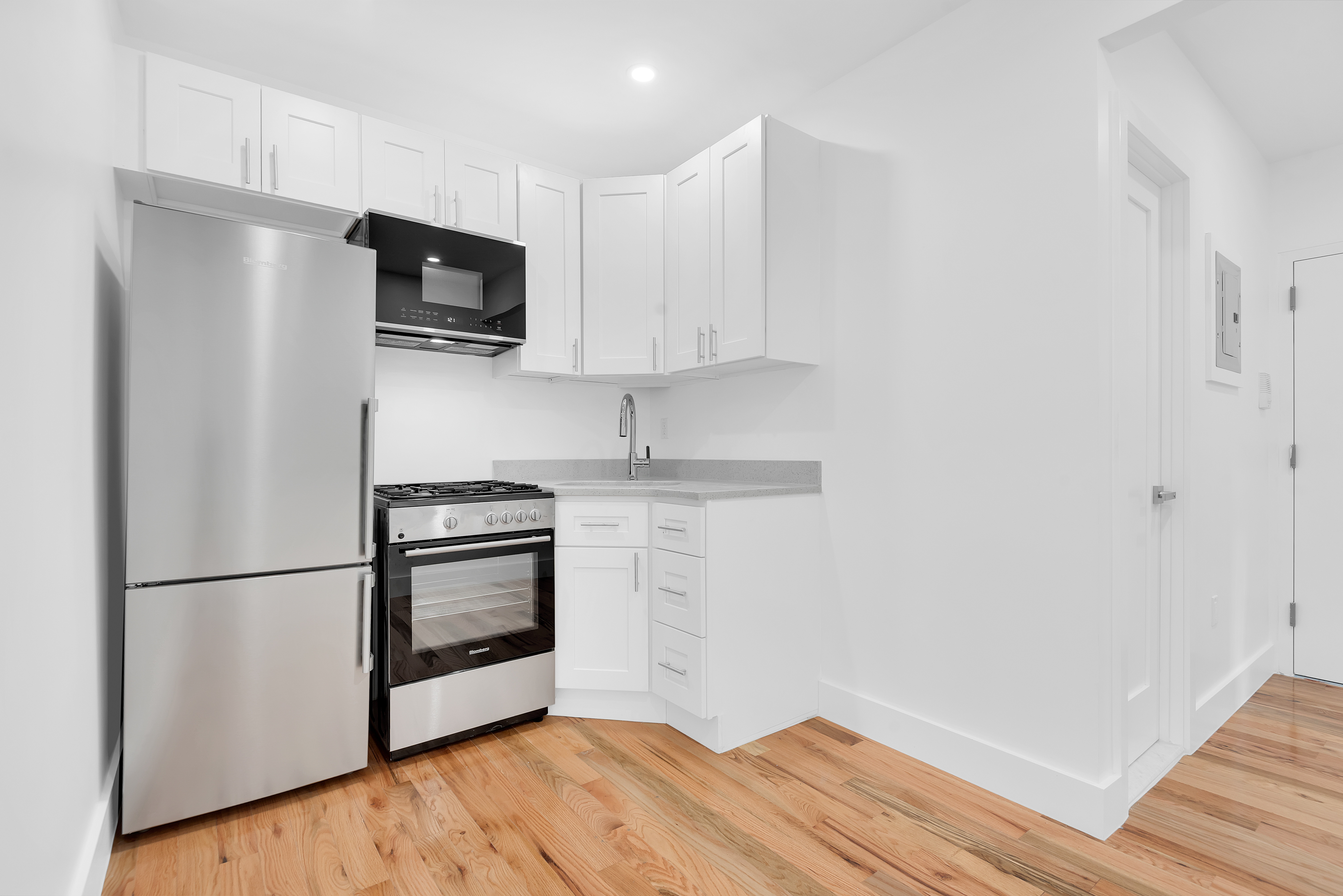 174 7th Avenue, Unit 3F Manhattan, NY 10011 - Photo 2 of 6 a kitchen with a refrigerator stove and microwave