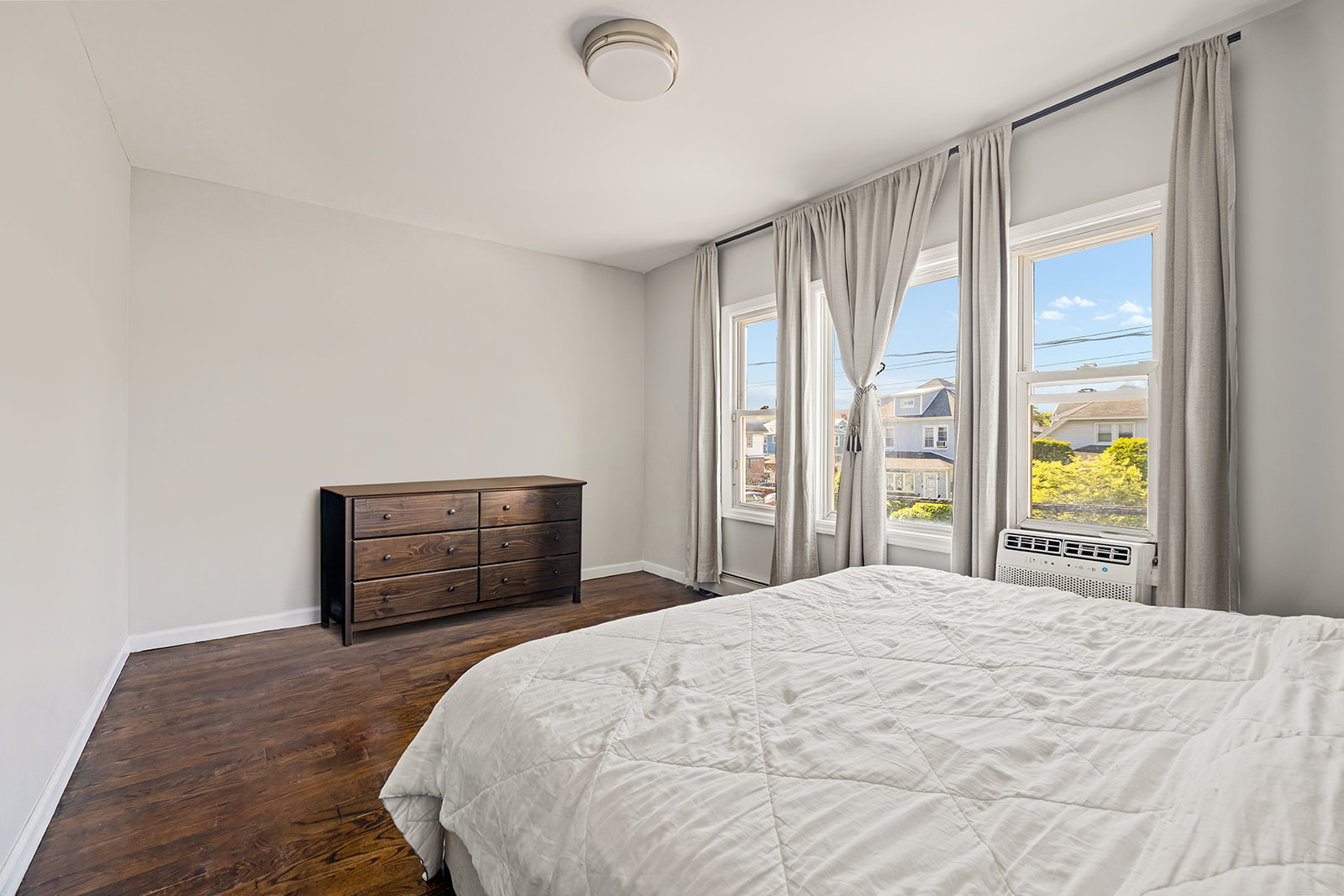 3815 Glenwood Road Brooklyn, NY 11210 - Photo 5 of 13 a bedroom with a large bed and a large window