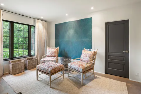 a living room with furniture and a floor to ceiling window