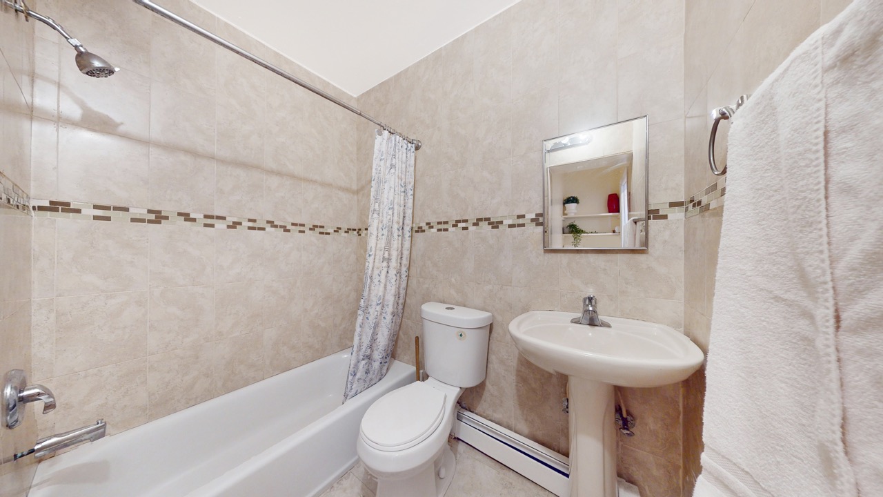 495 Central Avenue, Unit 2 Brooklyn, NY 11221 - Photo 15 of 19 a bathroom with a sink toilet and shower