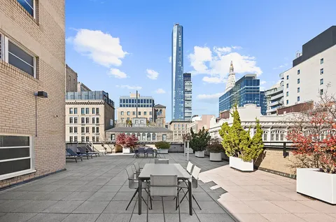 a view of a patio with couches table and chairs and potted plants