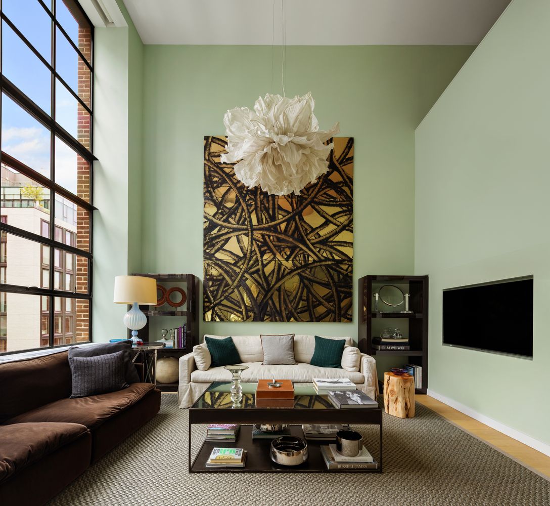 456 West 19th Street, Unit 6/7F Manhattan, NY 10011 - Photo 2 of 13 a living room with furniture and a flat screen tv