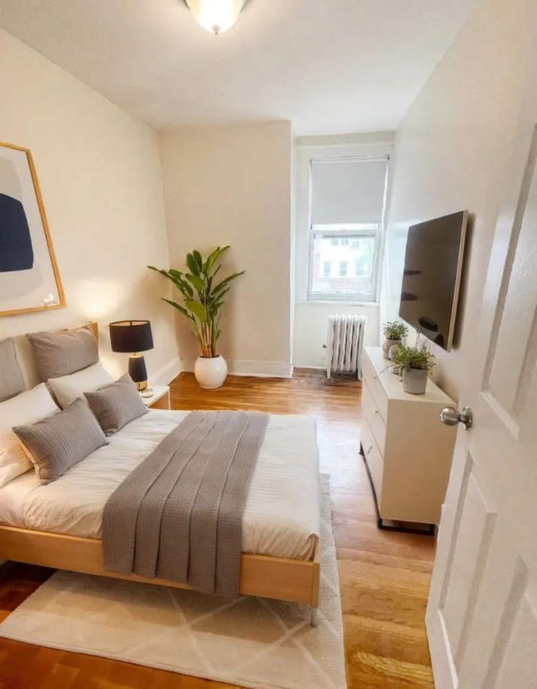 a bedroom with a bed and a flat screen tv